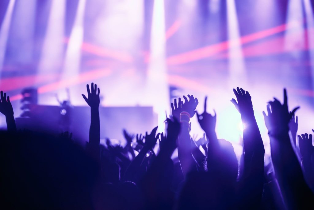 How do music venues enhance the concert-going experience?